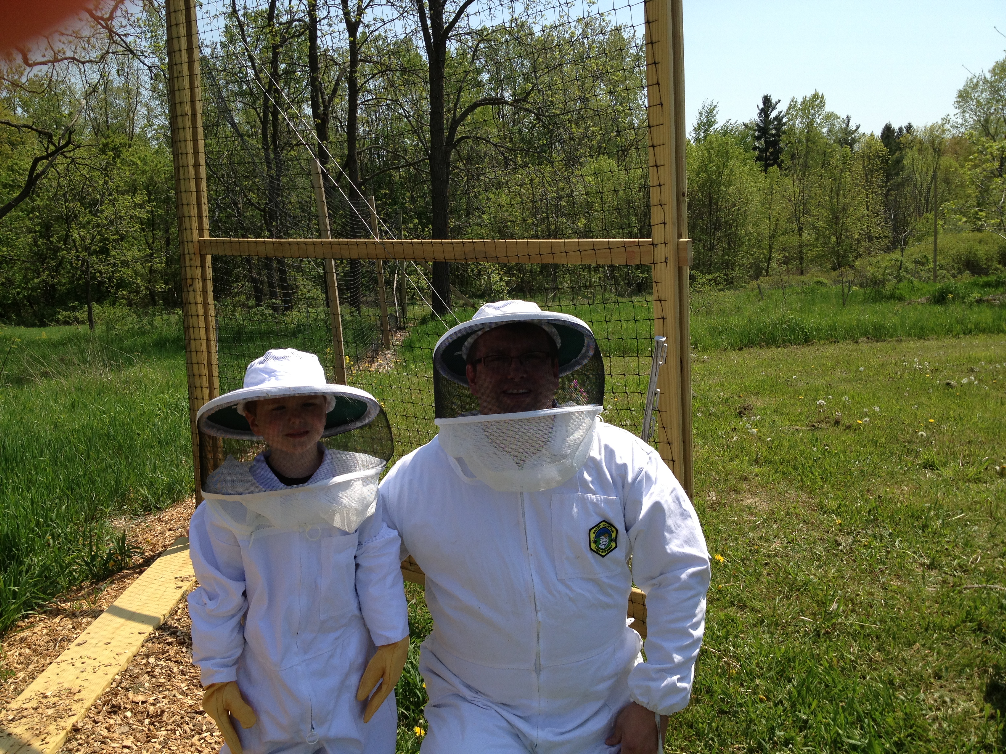Dad and Son Luke inspecting hives